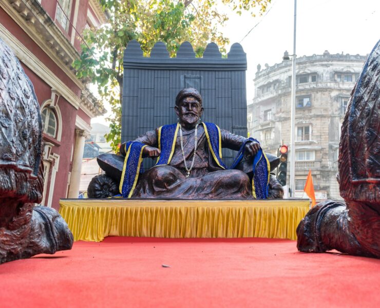 a statue of a man sitting on top of a table